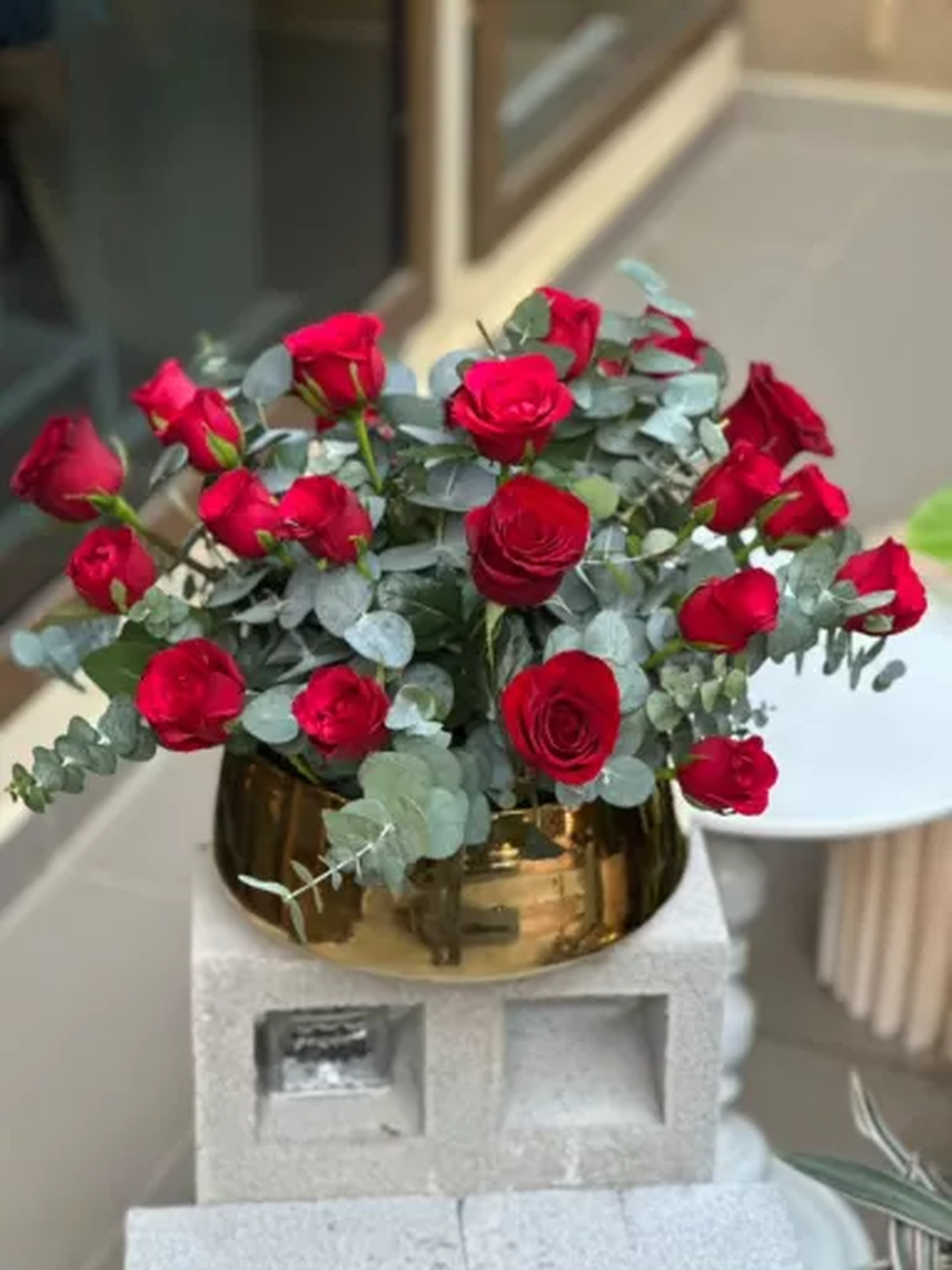 Red rose and eucalyptus vase arrangement