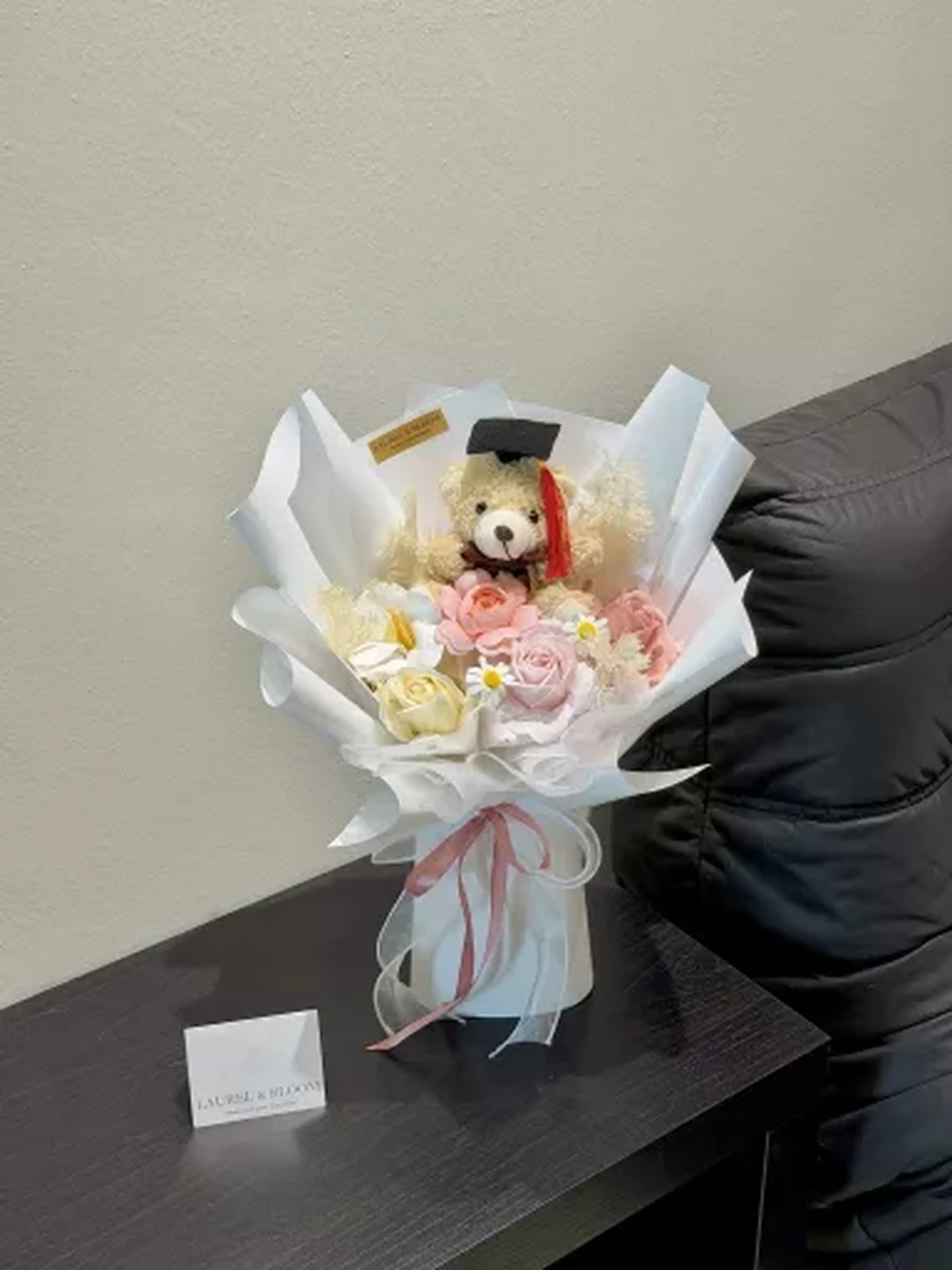 Pink graduation teddy bear bouquet with flowers