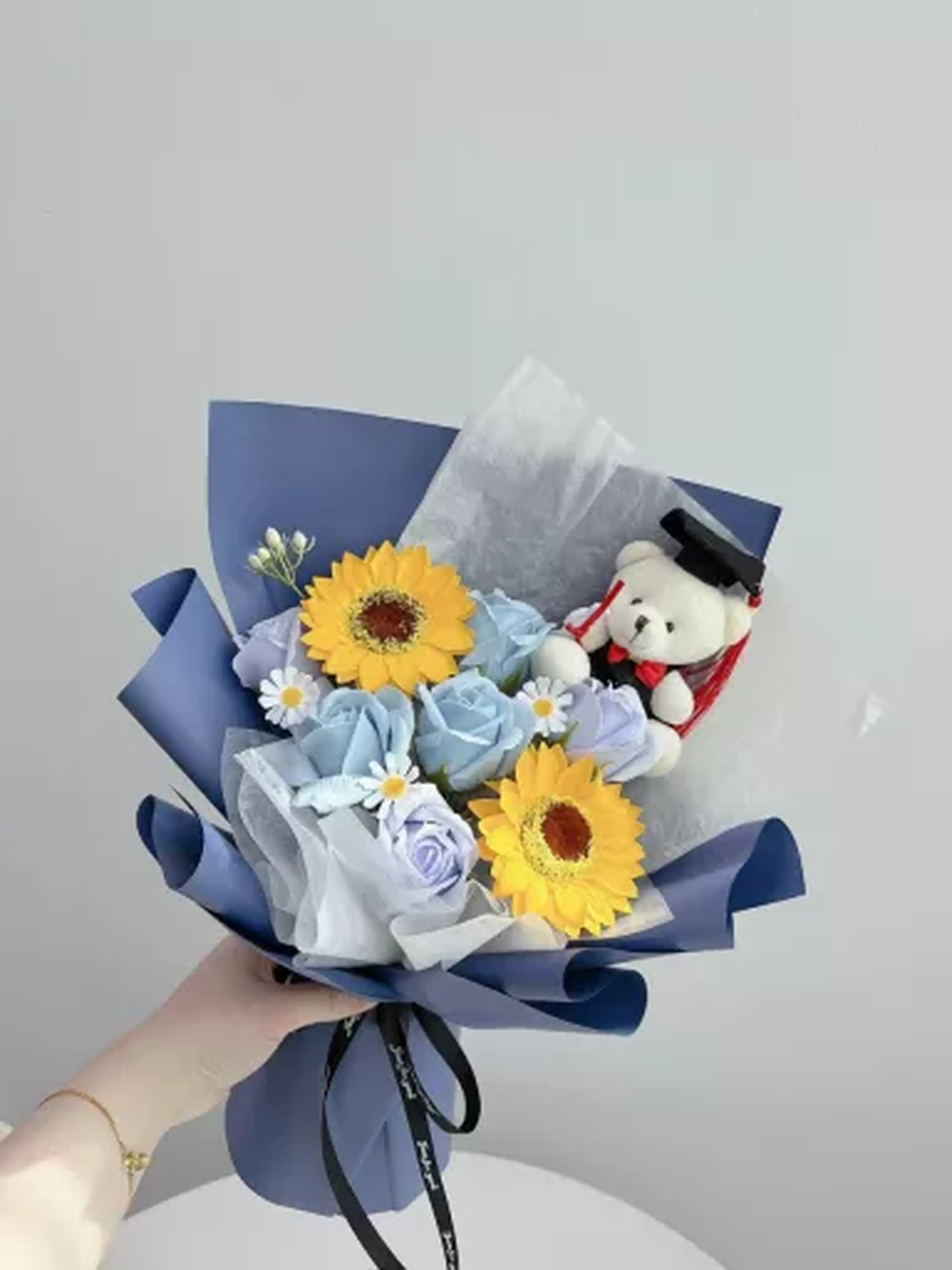 Blue and yellow soap flower graduation bouquet with teddy bear